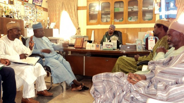 SUBEB chairman Alhaji Abdullahi Dabo (center) and board members listen to Chief of Party Ayo Oladini (left) present NEI’s project accomplishments during a courtesy visit.