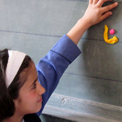 Girl playing on chalkboard in Jordan