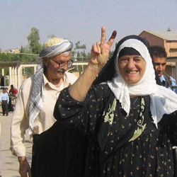 Afghan woman giving the peace sign.