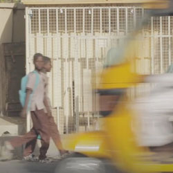 Nigerian boys walking on street.