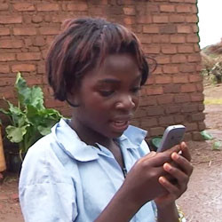 Zambian Girl using mobile phone.