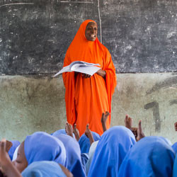 Nigerian woman teaching in classroom.