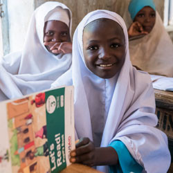 Nigerian girl reading in classroom.