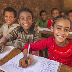 Ethiopian children writing in classroom.