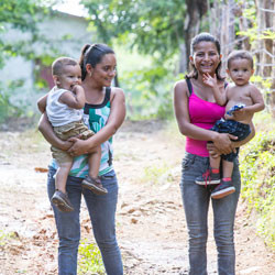 Honduran women walking with children.