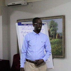 A Somali man speaks to a group.