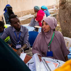 A poll worker speaks with voters during a Somaliland election.
