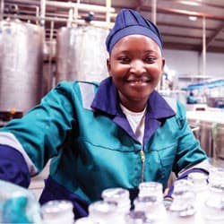 A woman in a bottling plant.