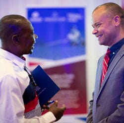 Two men smiling and talking at the launch of the Trade Hub