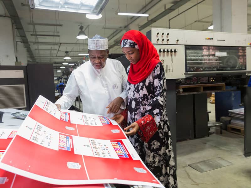 A man and woman review printed education materials.