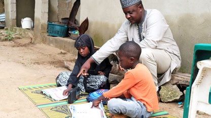 Father-supporting-children-to-listen-to-radio-lesson_home